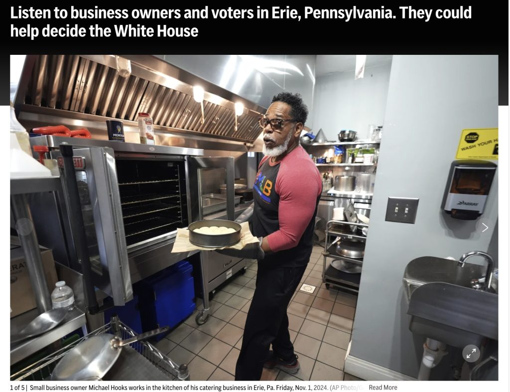 This image links to an apnews.com article highlighting, MMLB founder Michael R. Hooks, holding fresh biscuit straight out the oven he and a his team uses to serve the countless individuals and their familes. throughout the year.